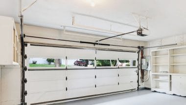 Inside a garage with white garage door