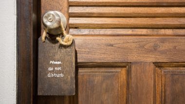 Wood door with a sign saying "Do not disturb"