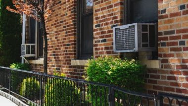 Loud Window Air Conditioner in a Brick Building