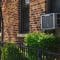 Loud Window Air Conditioner in a Brick Building